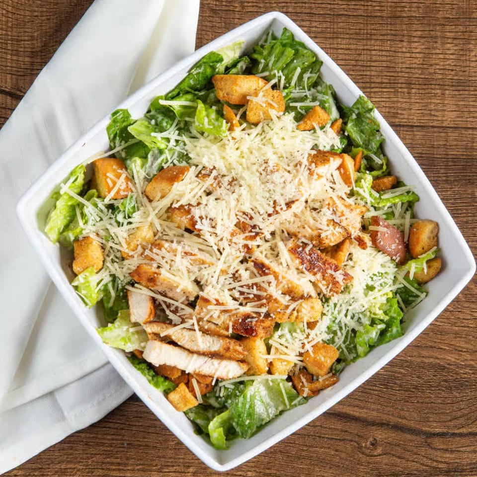 Rickey's Sports Bar & Grill's chicken Caesar salad with romaine, croutons, and parmesan.